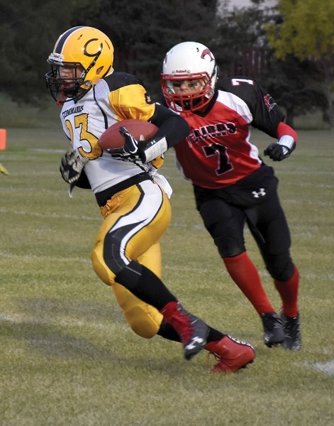 Thunderbird Robert Bokenfohr looks to tackle Wainwright Commando Dayton Gibb during the club’s Sept. 22 28-6 home loss.