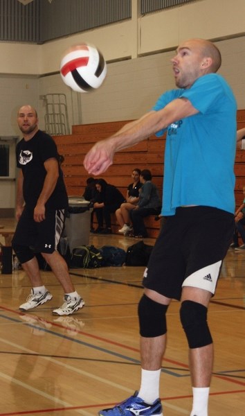 Andrew Kaliel bumps a ball during a semifinal match Sept. 23 at the annual R.F. Staples Alumni Volleyball Tournament. Kaliel played on the Doug Sereda 2011 squad, which