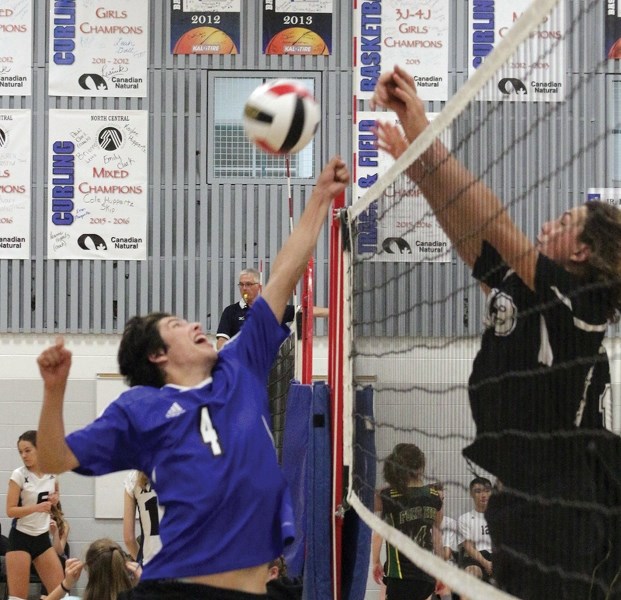Seventeen teams competed in the R.F. Staples Invitation Tournament Sept. 29-30. St. Mary Shark Shannon Corbett prepares to spike the ball as T-Bird Max Benham attempts to
