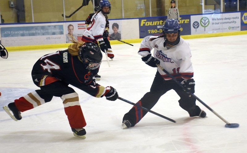 Black Gold Rush’s Brittany Kraychy (left) takes a swipe at Calgary RATH’s Rachel Grant at a National Ringette League game at the Rotary Spirit Centre Oct. 14.