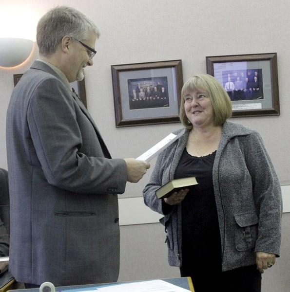 Westlock County CAO Leo Ludwig administers the oath of office to Lou Hall at the county’s Oct. 24 organizational meeting. Hall will serve the next 12 months as county reeve.