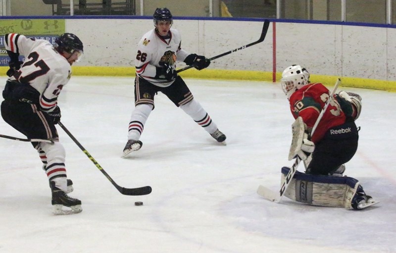 Westock Warriors Ryan Nelles and Philip Ferenac close in on Whitecourt Wild goaltender during the club’s 8-7 Nov. 4 victory at Rotary Spirit Centre.