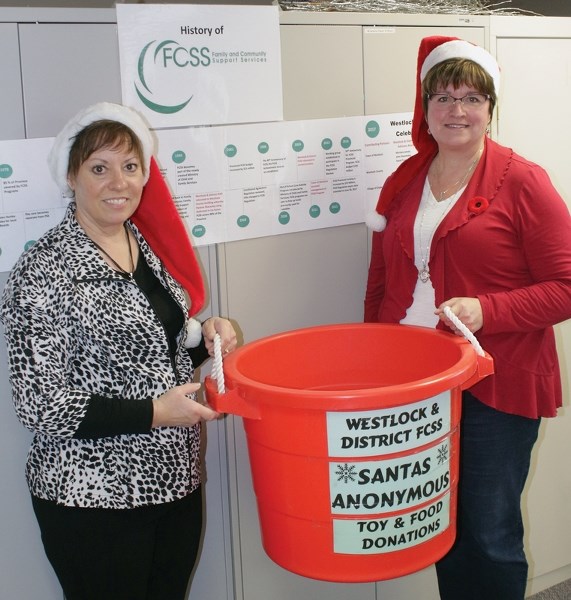 Westlock FCSS program assistant Bonnie Breadon (l) and program coordinator Carol Kassian show off a Santa&#8217;s Anonymous donation bin that will be placed in business