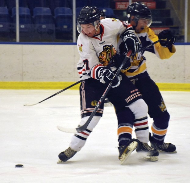 Westlock Warrior Taylor Heck edges out a Morinville King for the puck in a bitter rivalry that saw the Warriors fall flat in a 9-3 bout at the Rotary Spirit Centre Nov. 10.