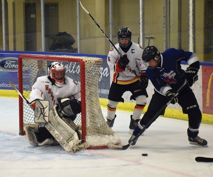 A ThunderStars opponent looks for a wrap-around on Warriors goalie Robert Zeise while Dylan Gabal hunts for the puck during the club&#8217;s 3-2 Nov. 11 home win.