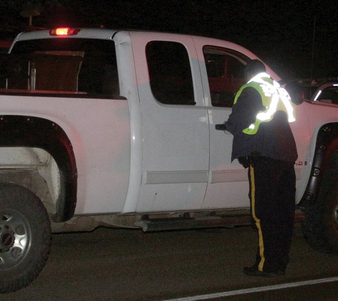 RCMP Const. Pavinder Grewal chats with a driver during a Dec. 2 checkstop on Highway 18 just past the golf course. RCMP are reminding drivers to stay sober this holiday