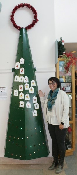 Loraine Oleski shows off the Tree of Hope in the lobby of Westlock Healthcare Centre Dec. 1. The hospital is hoping to fill the tree to help pay for a $12,000 pediatric