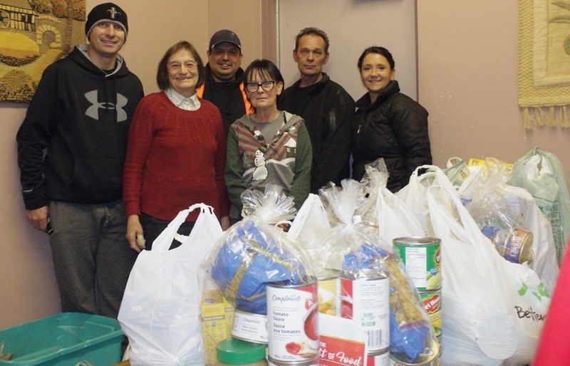 L-R: Darcy Plamondon, Hertha Hauch, Brian Hegedus, Helen Renaud, Mike Walmsley and Joanne Plamondon show off a delivery of food collected by the Town of Westlock Fire
