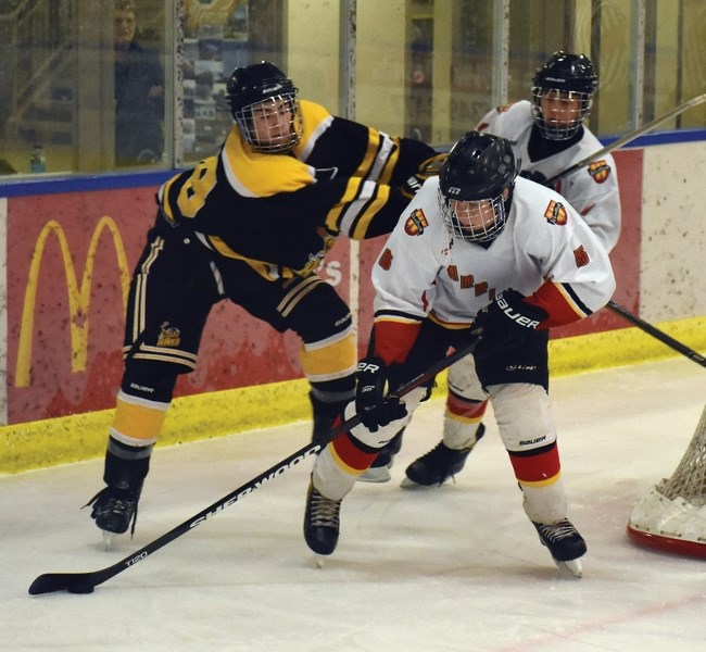 Westlock Warrior Blain Rinas fends off an attack from an Athabasca Hawk at Saturday night&#8217;s game at the Rotary Spirit Centre. The Warriors crushed the Hawks 6-0.