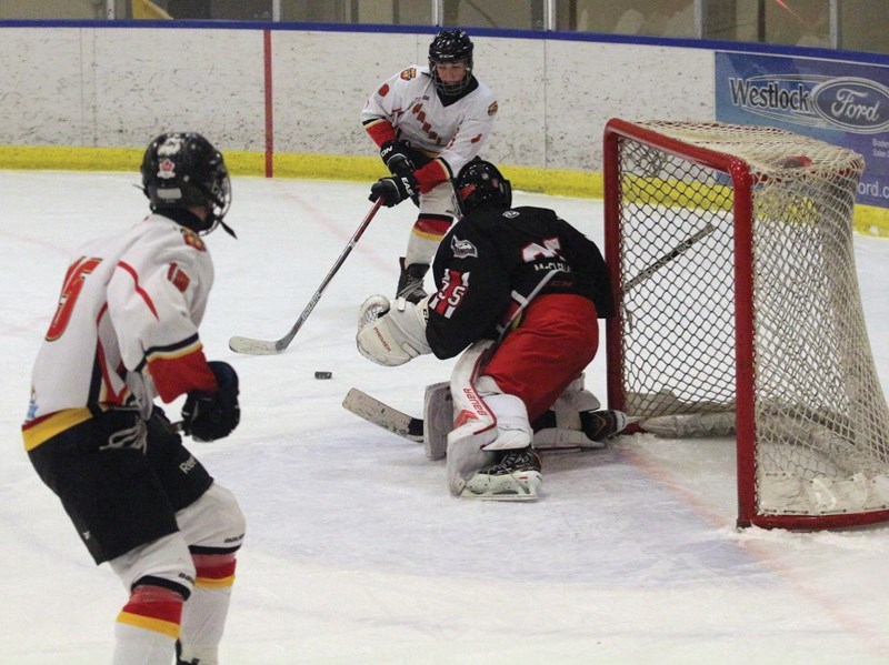 Westlock’s Addison Weir attempts to backhand a shot while teammate James Oloske drives the net during a 5-4 loss to the Camrose Axemen at the Rotary Spirit Centre Dec. 16.