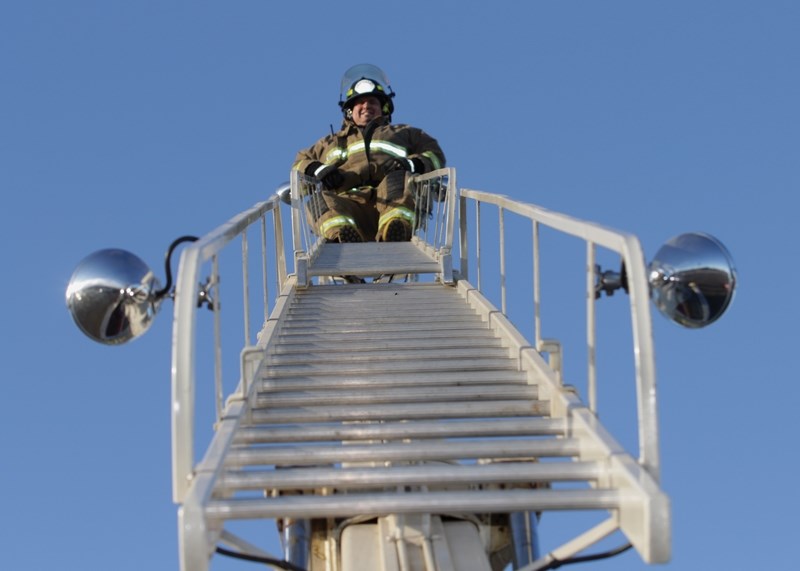 Town of Westlock Volunteer Fire Department Lt. Brian Hegedus sits back and relaxes atop a ladder truck for the Firefighter in the Sky fundraiser Dec. 17. The fire department