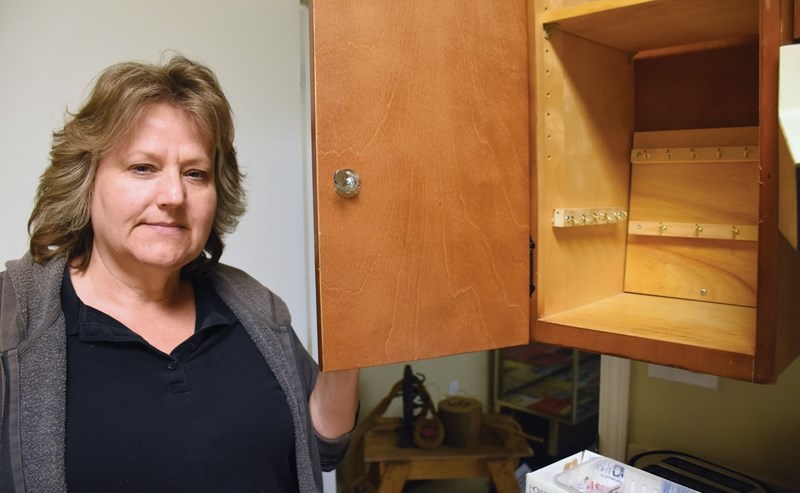 Canadian Tractor Museum secretary/treasurer and administrator Annette Schwab poses in front of the empty key cabinet thieves pilfered over the weekend.