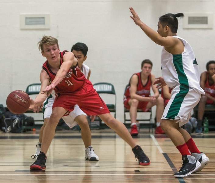 Thunderbird Evan Felstad passes the ball during a Dec. 13 73-69 road victory over the Athabasca’s Edwin Parr Composite School Predators.