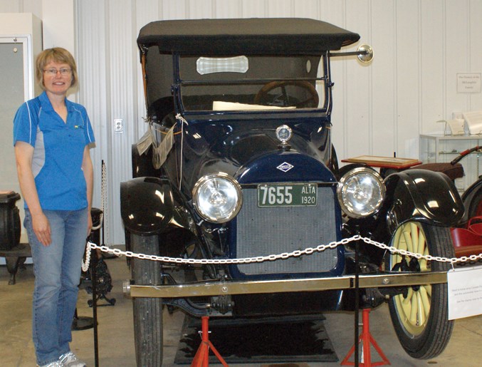  Restored by owners Leo and Flore Valcourt, museum supervisor Karen Letts stands beside a vintage 1920 McLaughlin.