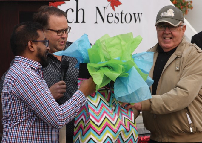  Town councillors Murtaza Jamaly and David Truckey presented deputy reeve Brian Coleman with a gift from the town — a clock with an inscription commemorating the special day.