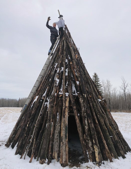  Edward Goodliffe places the effigy of Guy Fawkes on top of the 24-foot stack of wood that was set ablaze.