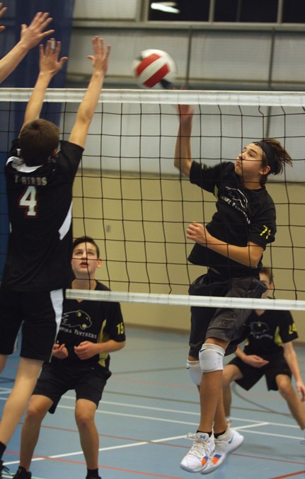  Christopher Pechanec from PNCS taps the ball over the net in a game against R.F. Staples.