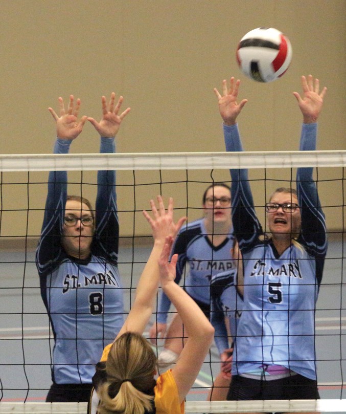  Sharks’ Jenna Schwarz and Elise Terrault jump for a block with Morgan Calladine in the rear.