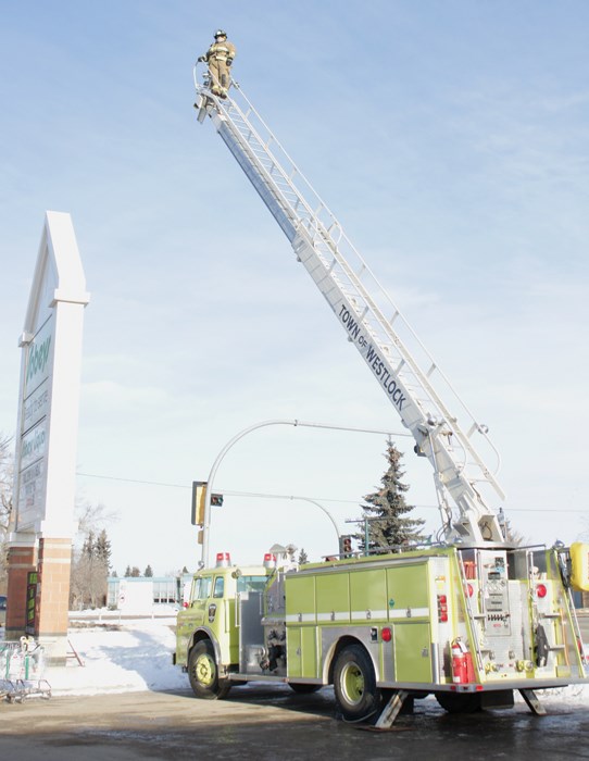  Town of Westlock Volunteer Fire Department Lieut. Brian Hegedus surveys the town during the third annual Firefighter in the Sky event Dec. 16 at Sobeys. That day the department collected 1,007.4 pounds of food and $1,636.80, plus a bag a clothing.