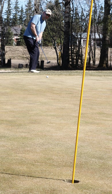  Lorry Butz, who came all the way from Redwater to hit the links, goes for a long putt on the seventh hole at the Westlock Golf Course April 13. Butz was one of 80 golfers to play the front nine of the course, while the back nine is expected to be open in a few days.