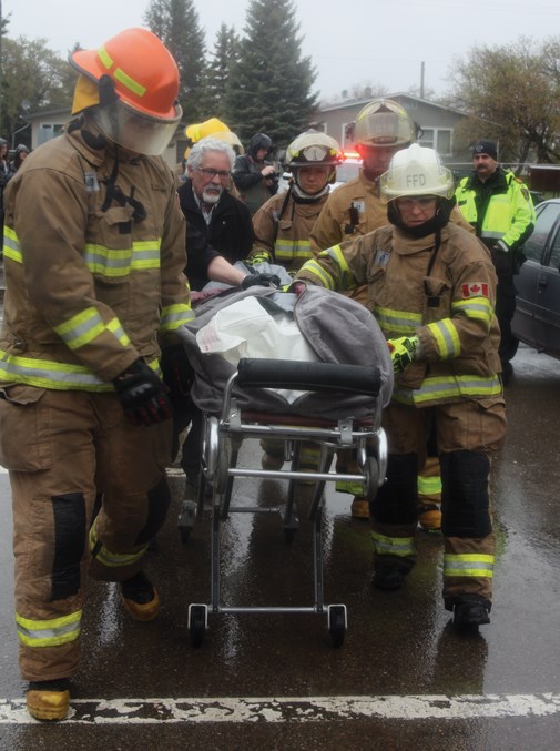  Firefighters extracted the driver of the other car with a hydraulic rescue tool and turned him over to emergency medical services which took him away in the ambulance.