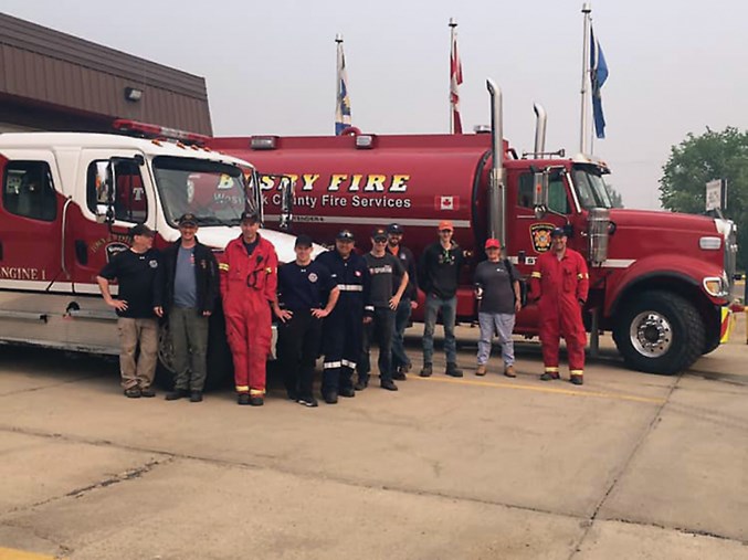 Firefighters and equipment from town and county fire services were called in to assist Slave Lake firefighters May 30. L-R: William Smith, Trevor Ehrenholz, Jared Stitsen, Joe Down, Brian Hegedus, Jesse Plamondon, Shane Goossen, Matthew Punko, Roberta Halliday and Todd Terrault will provide assistance in manpower and equipment in the form of an engine, tender and a brush truck.