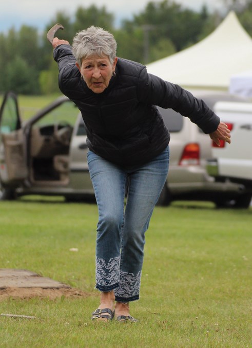  At the horseshoe pits behind Jarvie Community Hall, Marg Wintonyk sets up her throw for a ringer. Behind her, people had already gathered for the lawnmower races, all part of the July 27 Jarvie Days celebrations.