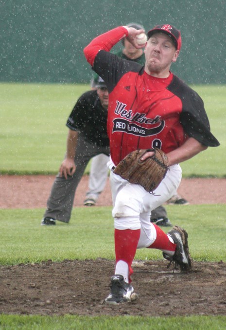  Red Lions pitcher Kris Johnson delivers a pitch in the rain during Game 1 of the team’s July 28 doubleheader against the Edmonton Blackhawks at Keller Field.