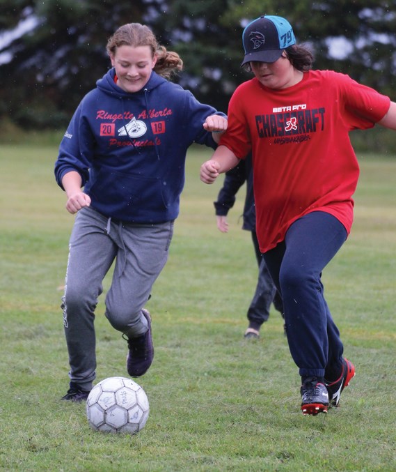  Students from six area schools gathered in Fawcett Sept. 26 for the annual Pembina Hills Divisional Junior High Soccer Tournament. Pictured, R.F. Staples’ Jolie Snow and Sebastian Hoblak run to get control of the ball.