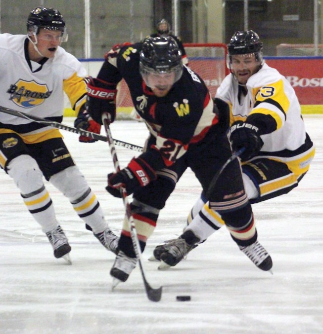  Nathan Brown races for the net with two Devon Barons players on his tail. The Warriors lost Oct. 11 game at the Rotary Spirit Centre 5-4, but recovered the next day with a 4-3 win over the Eckville Eagles.