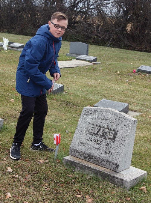  Parker Evans from Pembina North Community School places a flag on a veteran’s grave Oct. 24 at the Jarvie Community Cemetery as part of No Stone Left Alone ceremonies. Similar events will take place throughout the region and across Canada this week as Remembrance Day draws closer.