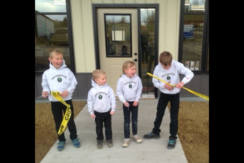 Ten years ago on opening day the Vanderzyl children were overjoyed to participate in the ribbon cutting ceremeony to open Integ Distributorson April 13, 2015. L-R Renauld, Cedric, Margaret, and Wesley. Photo supplied.