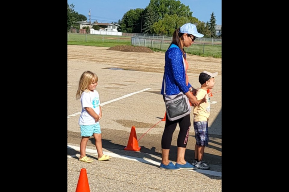 Aubrey Tilme, Jenna and Ayden Rowbottom board the school bus for the children's first experience riding on a school bus.