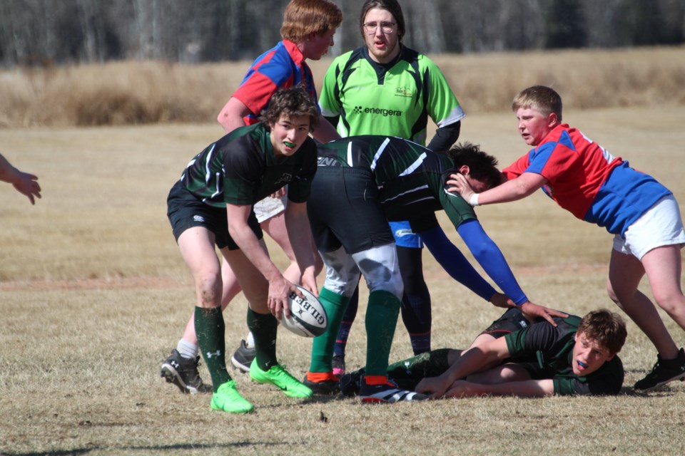 Jake Safar gets ready to pass the ball along after a ruck during the Predators April 19 game against Smoky Lake. Wyatt McKinnon looks on after getting tackled. Both students got to play at home for the first time in two years as the Predators hosted their first-ever tournament, where EPC finished in third place with a 2-2 record. 