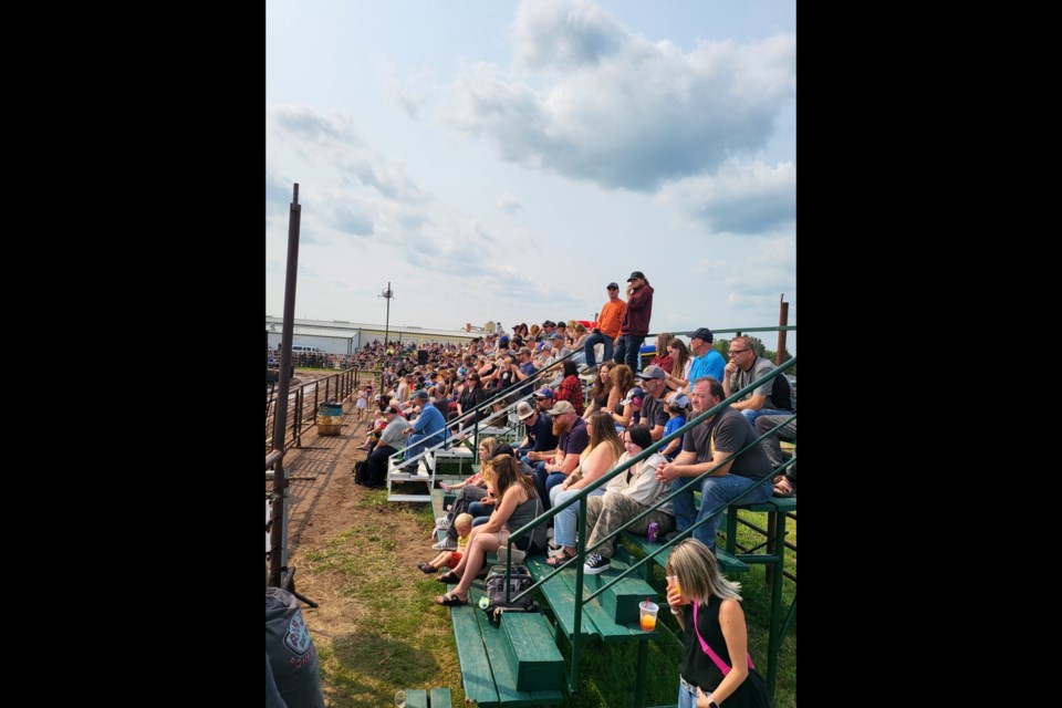 Demolition Derby north side bleachers full with a captivated crowd watching the derby heats.