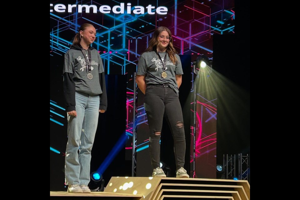 Karley Regimbald being awarded gold for intermediate hairstyling in her grade 10 year.