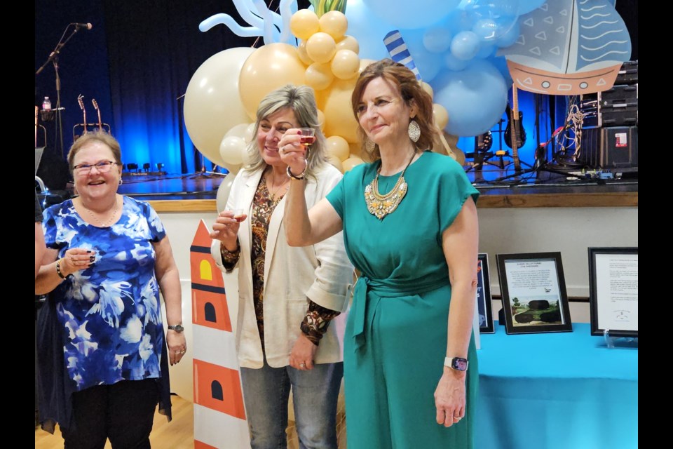 Soul Sisters Memorial Foundation president, Christine Vachon, raises her glass before the traditional "screech-in" Saturday night.  