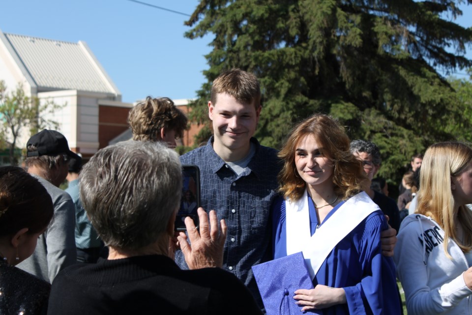 Graduate Bryar Woodcock (right) poses for a photo with her partner Bret Warwaryk (left) after the ceremony. 