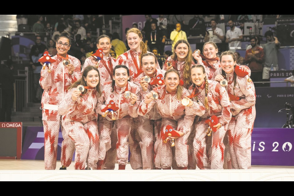 Neerlandia resident Heidi Peters (front row, third from left) poses with the rest of the Canadian Women's Sitting Volleyball Team in what they affectionately call their "bacon suits" after being presented with their bronze medal at the Paris Paralympic games.