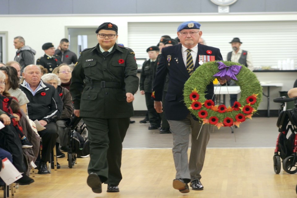 Cadet Lashonda Moore escorts veteran Wayne Inkpen, who laid a  wreath on behalf of Canadian peacekeepers during the Westlock Remembrance Day service Nov 11. 