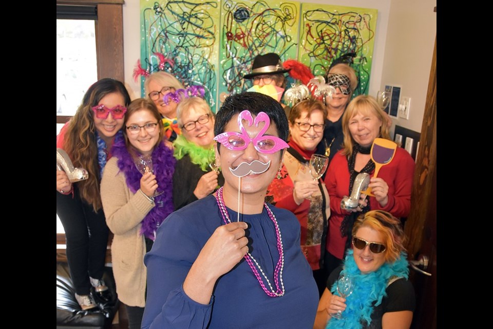 Fatima Amarshi (at front), the managing director of PoMoArts, with staff and volunteers at the Port Moody arts hub in 2018 as they promoted the Girls Night Out fundraiser.