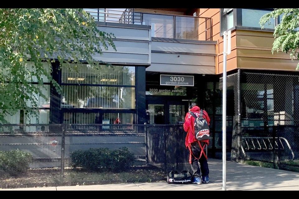 A man uses illegal drugs outside of 3030 Gordon Ave., in Coquitlam, at 10 a.m. on Friday, Sept. 8, 2023.