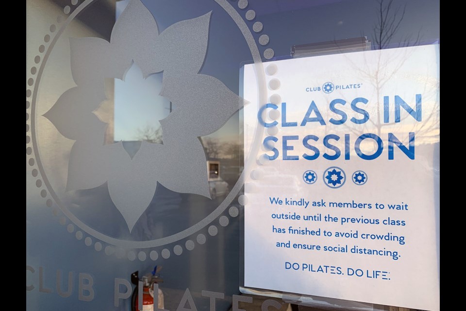 A notice on the front window that indicates a class is in session.