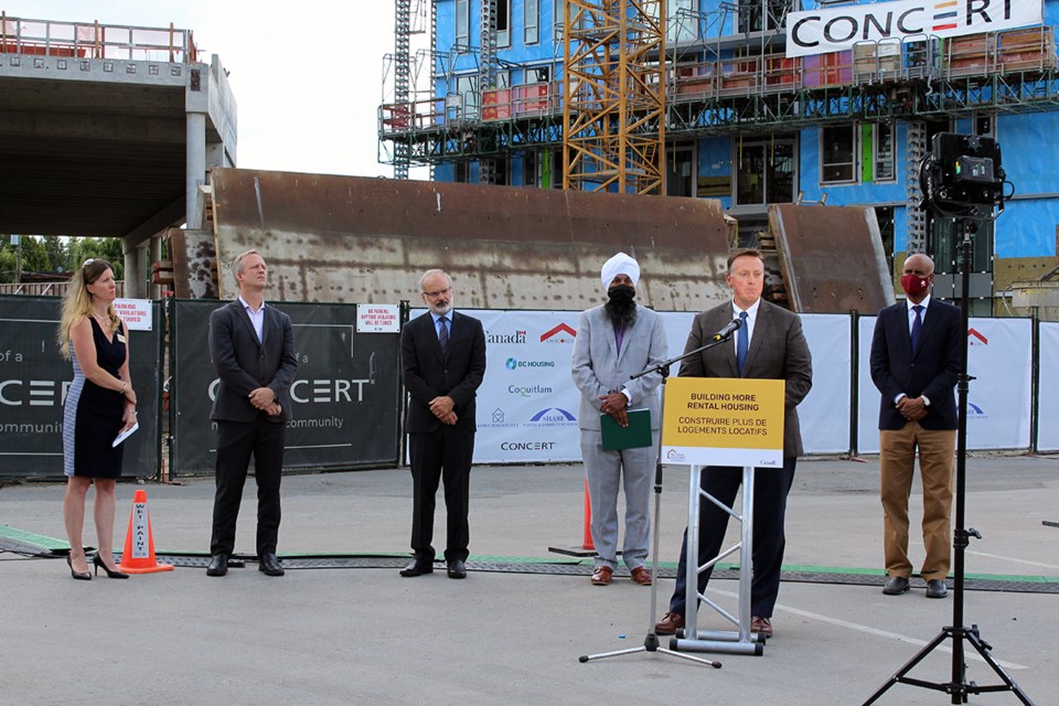 Left to right: Claire MacLean, CEO of SHARE Community Services Society/43 Housing; Rick Glumac, MLA for Port Moody-Coquitlam; Coquitlam Mayor Richard Stewart; Randeep Sarai, MP for Surrey Centre; Brian McCauley, president and CEO, Concert Properties (at podium); and Ahmed Hussen, Minister of Families, Children and Social Development and Minister Responsible for Canada Mortgage and Housing Corporation (CMHC).