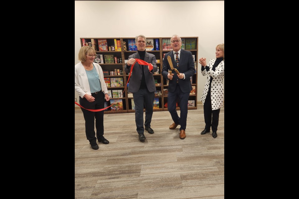 Coquitlam–Burke Mountain MLA Fin Donnelly, Coquitlam Mayor Richard Stewart and library officials cut the ribbon to mark the opening of the lounge at the Poirier branch in November.