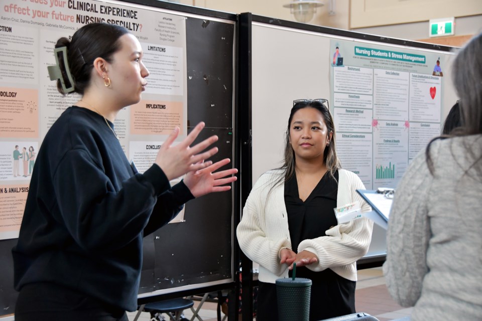 A student offers an explanation of a presentation at the 2024 Douglas College Student Research Days at the Coquitlam campus on April 9, 2024.