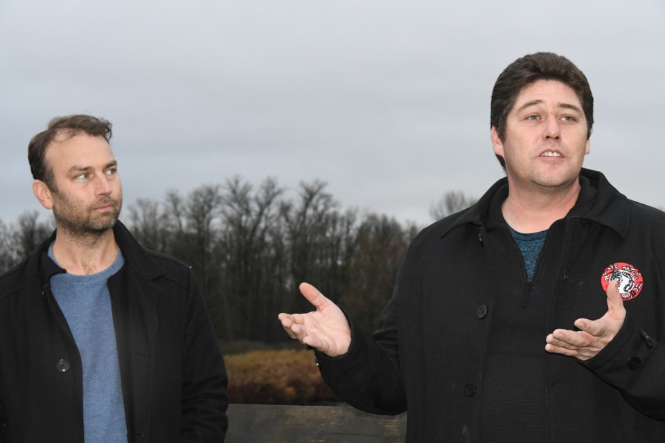 Dan Straker of MakeWay Charitable Society (left) with KFN Coun. John Peters on the Millennium Bridge, after the news conference on Dec. 14, 2023, in Coquitlam.