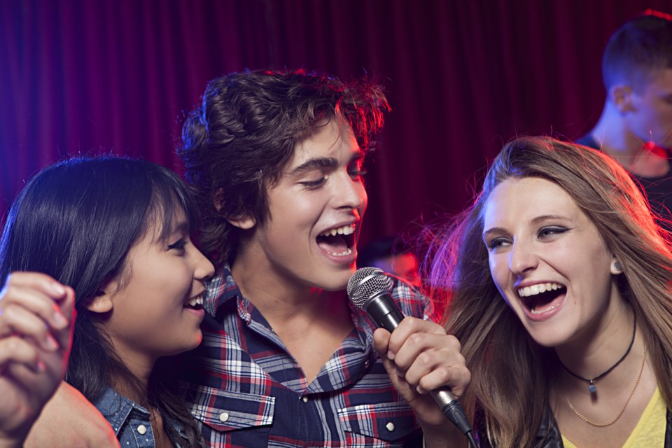 singer on stage with girls