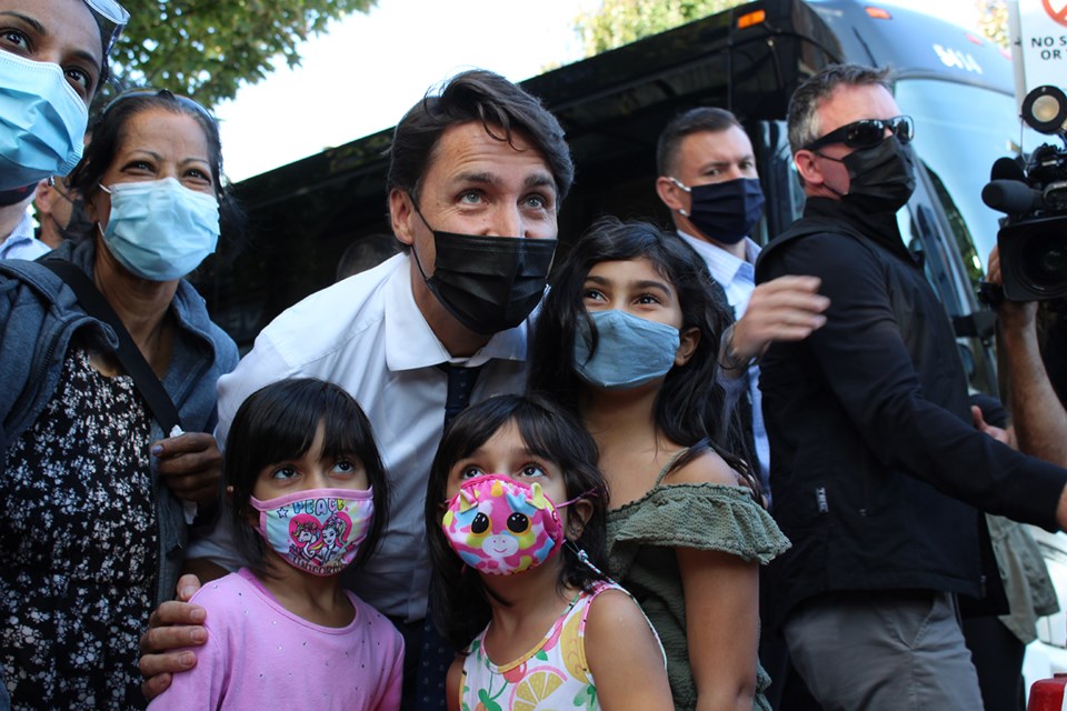 Justin Trudeau poses for a photo with a family in Port Coquitlam during Monday's stop.