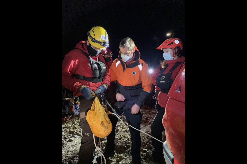 Jordan checks the rope work before the Coquitlam SAR team prepares to rappel.